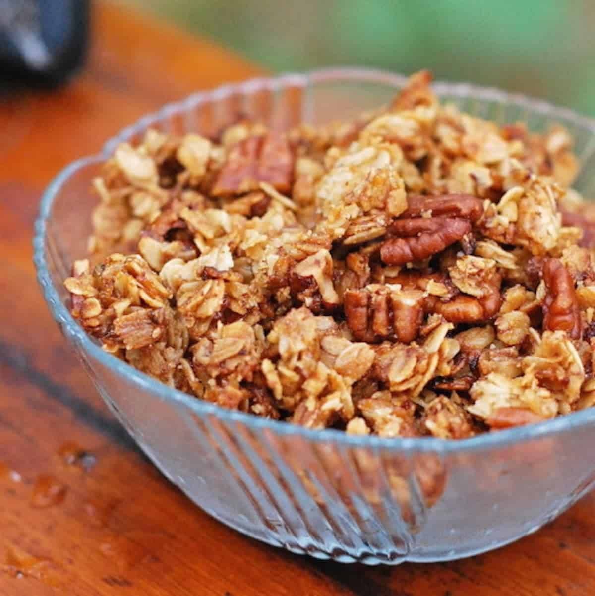 Pecan granola in a decorative glass bowl.