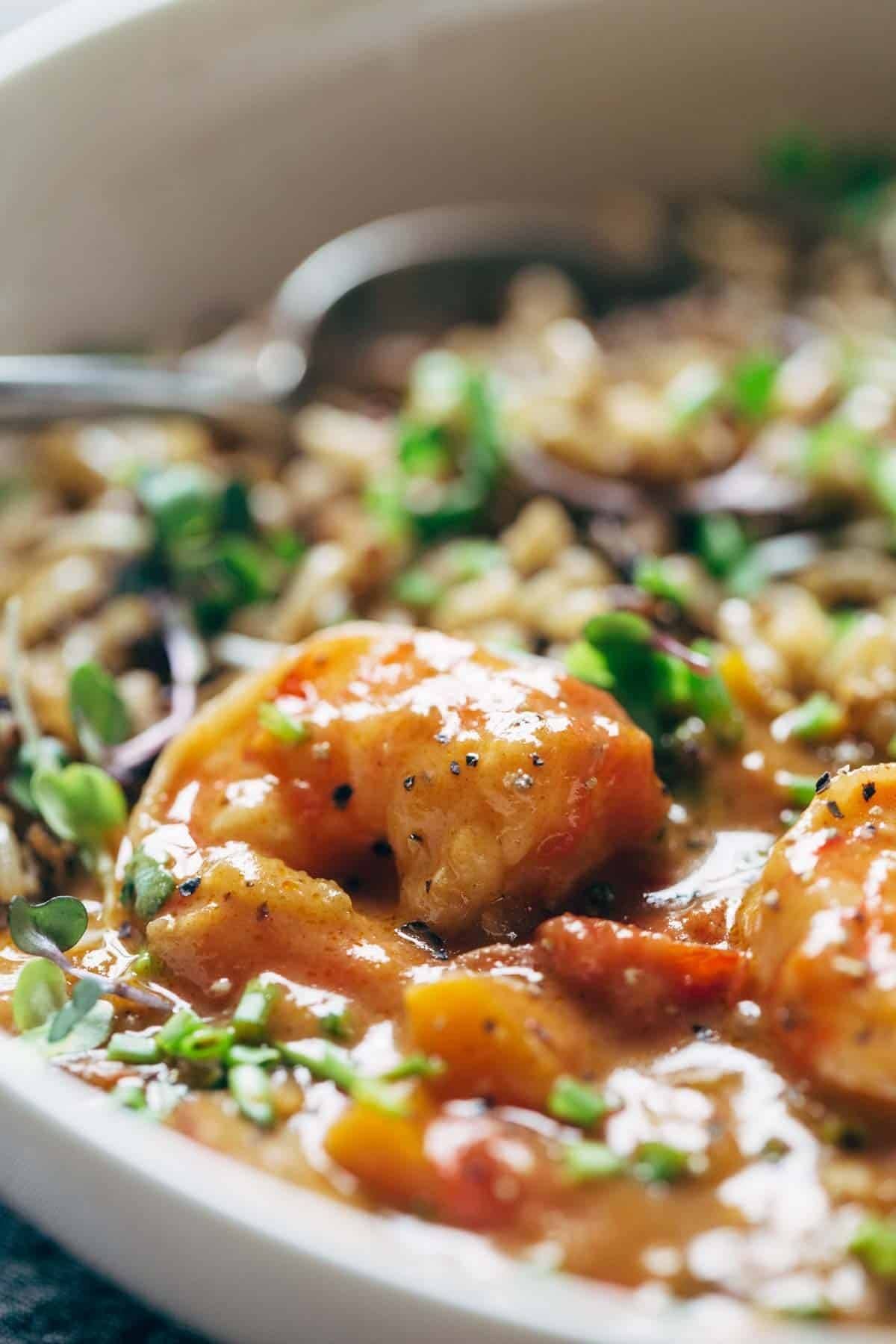 Gumbo shrimp with rice in a bowl with a spoon.