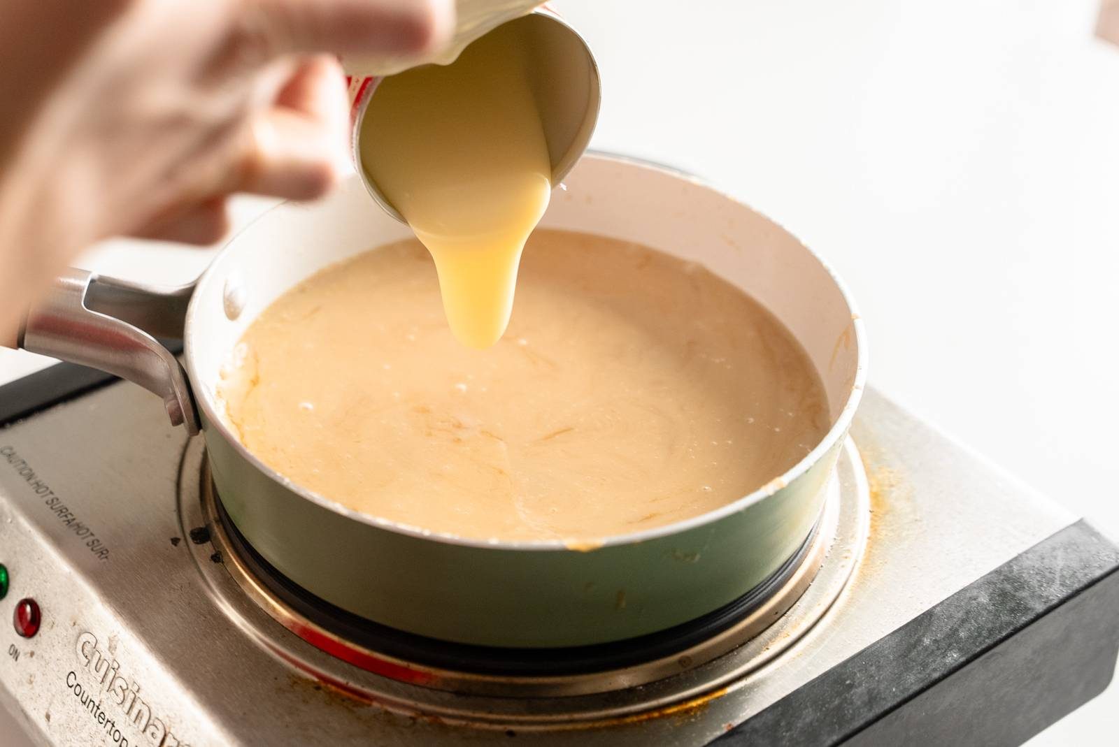 Cooking toffee layer on stove.