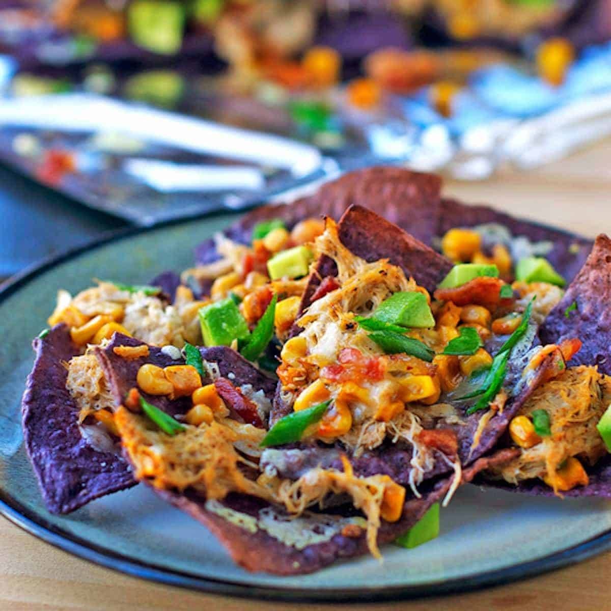 Crab avocado nachos on a blue plate.