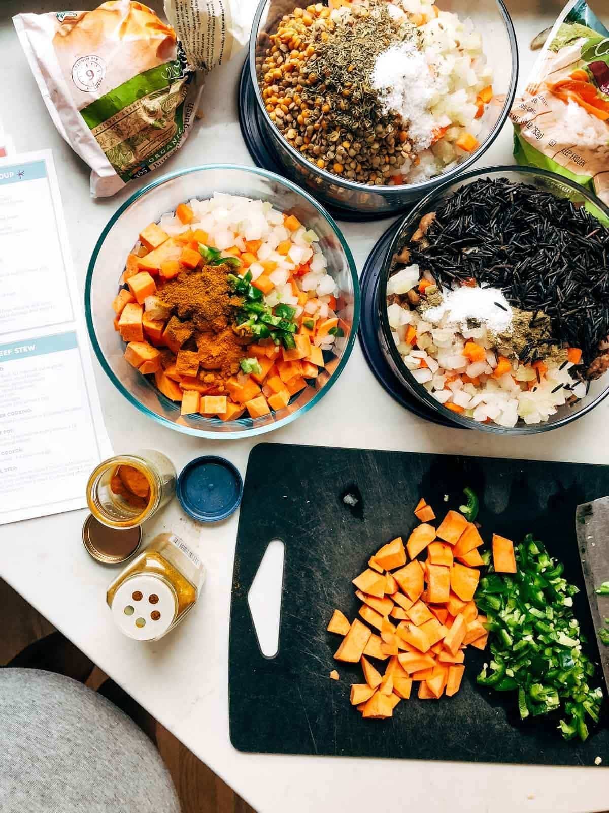 Various freezer meals in glass containers ready to go in the freezer.