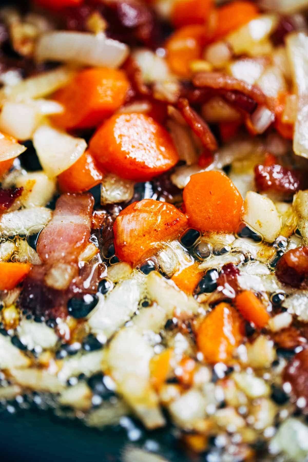 Simple Homemade Tomato Soup with carrots, onions, garlic, tomatoes, broth, and bacon for deliciously rich flavor. Extremely easy to make! | pinchfoyum.com Veggies sautéing for tomato soup